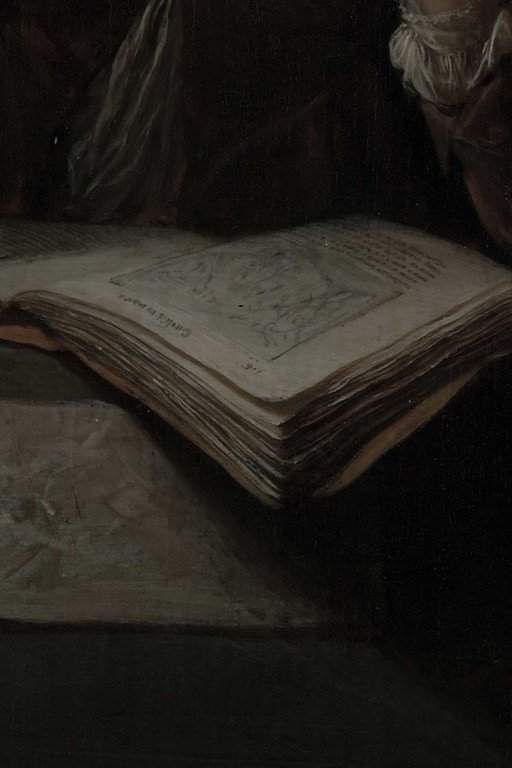 Ancient Open Book with Handwritten Text in Candlelit Study