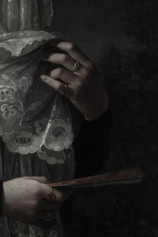 Hands Holding Ornate Lace Fan in Dark Gothic Portrait