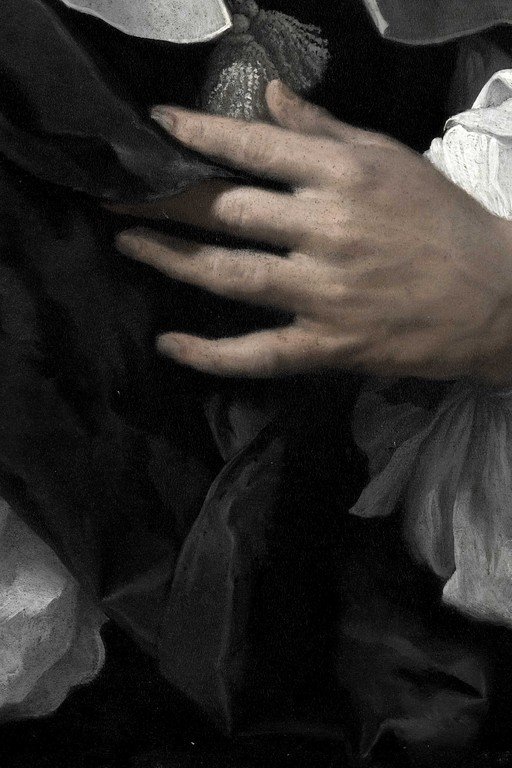Child's Hand Holding Shimmering Object in Black and White
