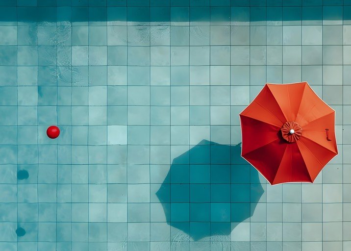 Red Umbrella and Ball in Tiled Swimming Pool