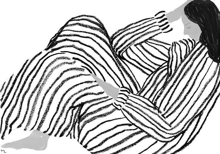 Woman in Striped Pajamas Reading on Phone