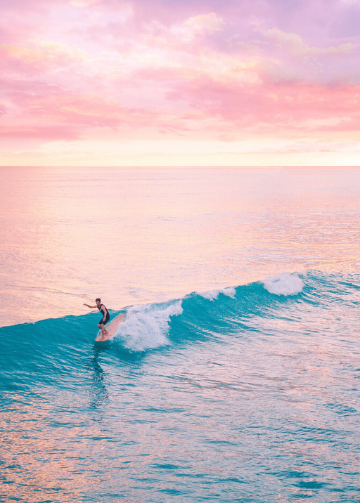 Surfer Rides Turquoise Wave at Sunset