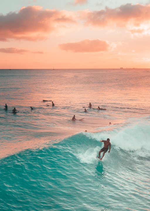 Surfer Rides Turquoise Wave at Sunset
