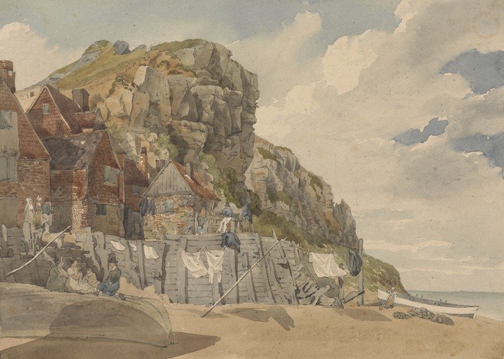 Coastal Village Scene with Rocky Cliffs and Beach