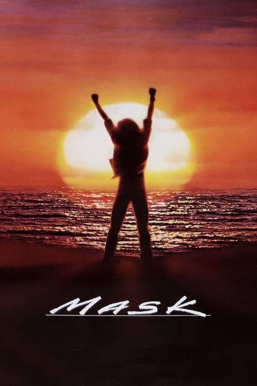 Person with arms raised against a sunset over the ocean