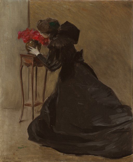 Woman in Black Admiring Red Flowers