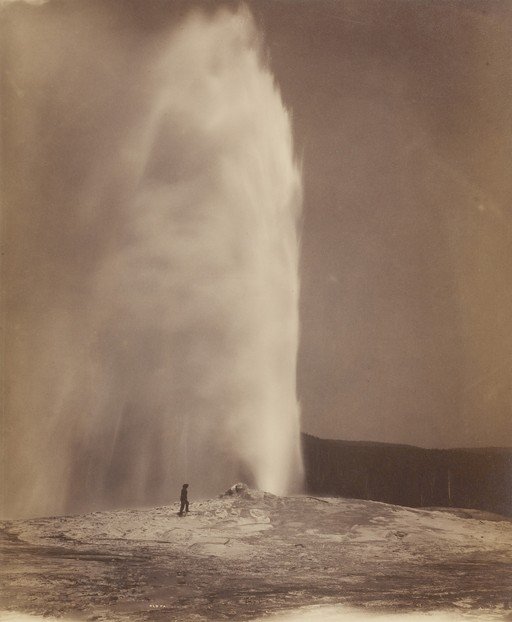 Old Faithful Geyser Eruption with Lone Figure