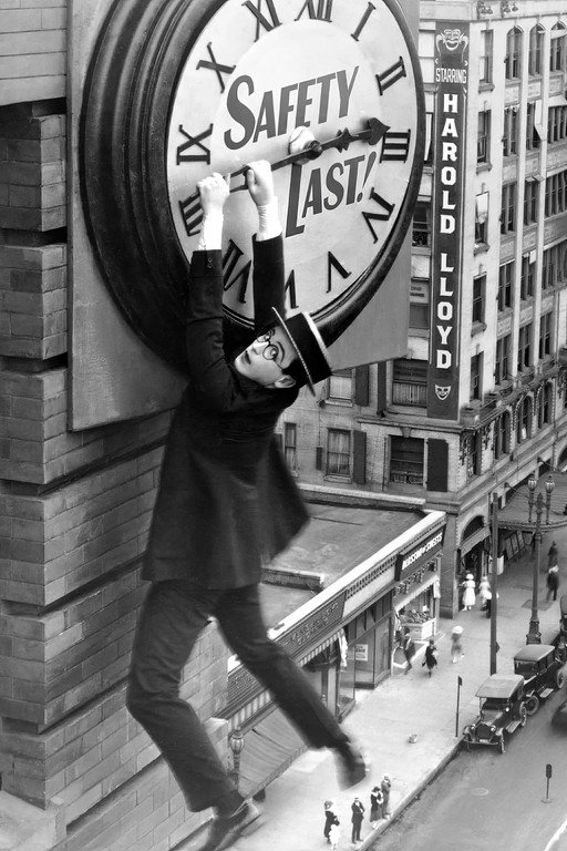 Harold Lloyd hangs from a clock in Safety Last!