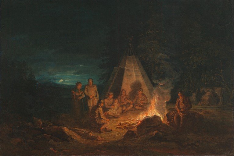 Indigenous People Gather Around Campfire at Night